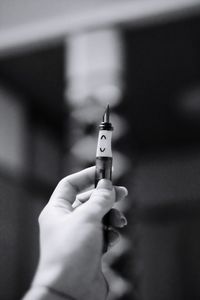 Close-up of hand holding cigarette