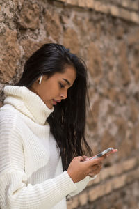 Young woman using mobile phone outdoors