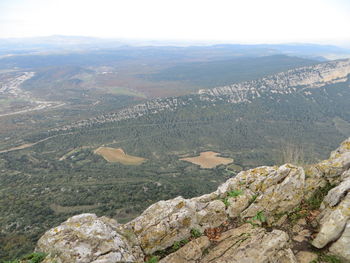 High angle view of land and mountains against sky