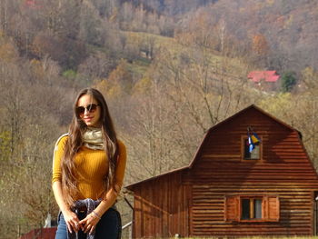 Portrait of woman standing against mountain