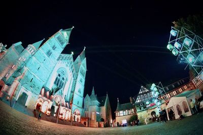 Low angle view of buildings in city at night