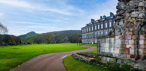 The palace of holyroodhouse edinburgh scotland including the ruins of the abbey.