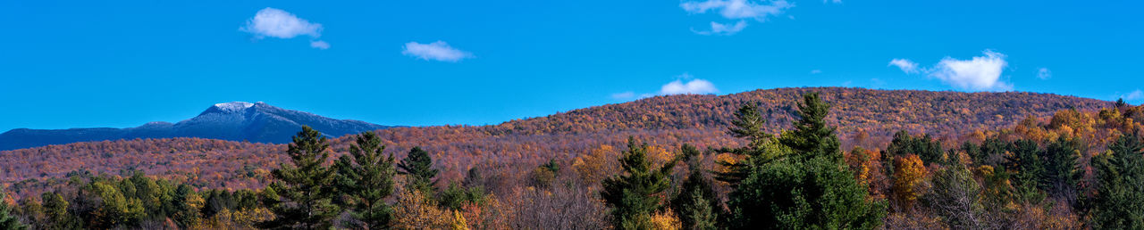 Panoramic view of mountain range against blue sky