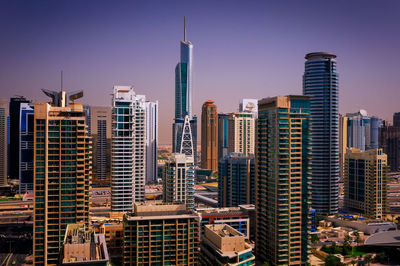 Modern buildings in city against clear sky