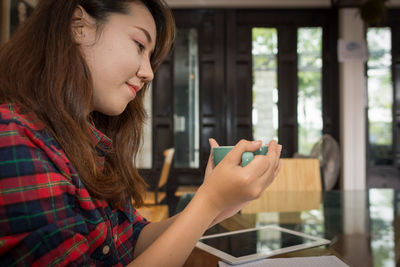 Portrait of woman using mobile phone