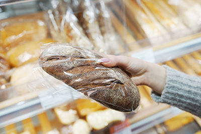 Close up of woman holding a bread in the market