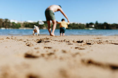 People on beach against sky