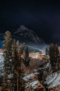 Scenic view of snowcapped mountains against sky at night