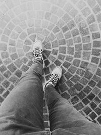 Low section of person standing on tiled floor