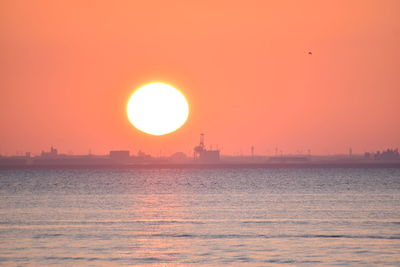 Scenic view of sea against orange sky