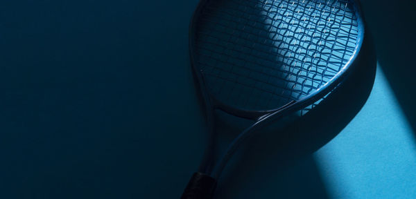 High angle view of electric lamp against blue background