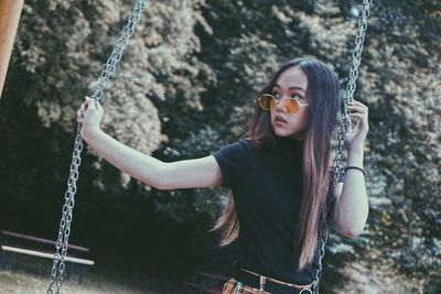 Young woman on swing at playground