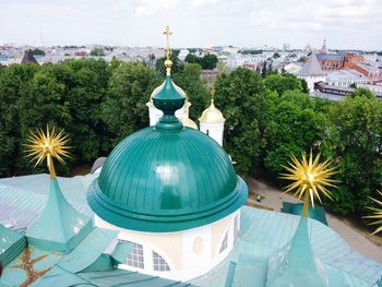 Scenic view of buildings and trees against sky