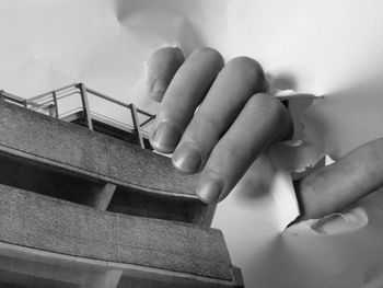 Close-up of hands holding piano