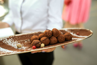 Close-up of hand holding dessert