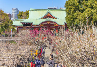 Group of people in traditional building against sky