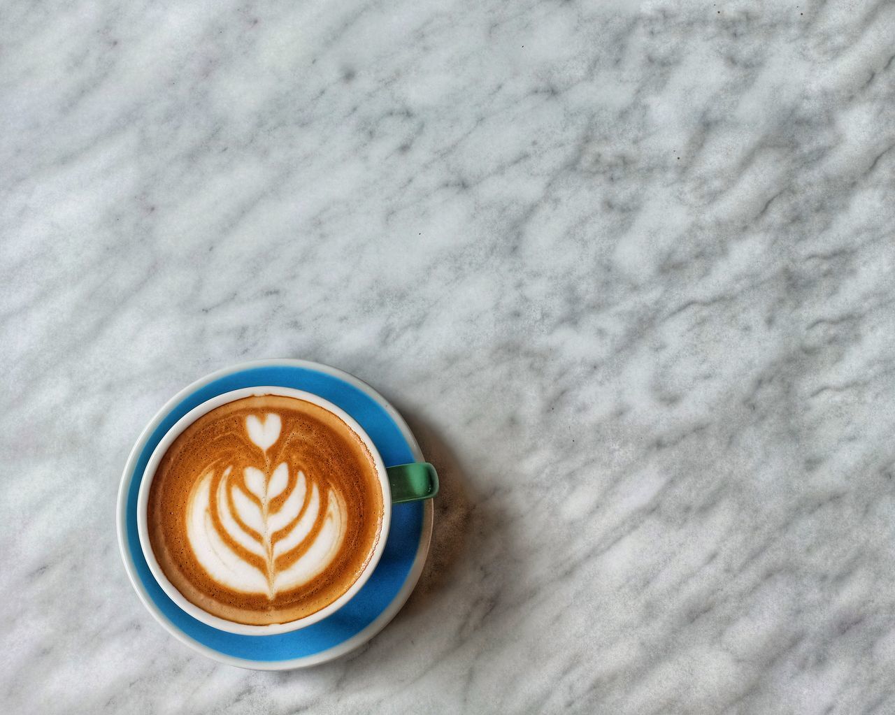 DIRECTLY ABOVE SHOT OF CAPPUCCINO WITH COFFEE CUP ON TABLE