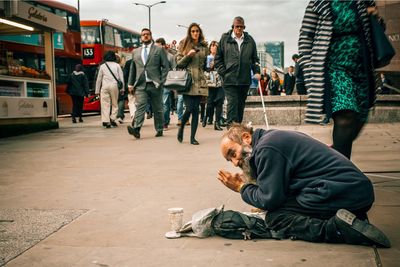 People sitting on footpath