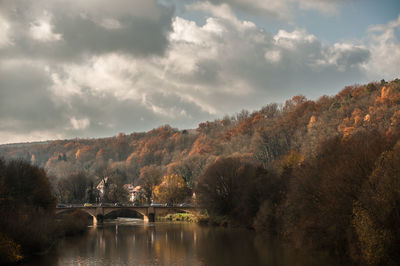 Arch bridge over river against sky