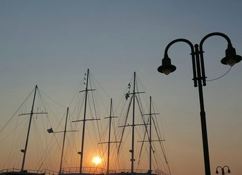 Low angle view of street light against sky at sunset