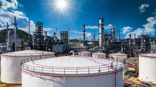 Oil and gas refinery plant and storage tank form industry zone with blu sky background, oil and gas