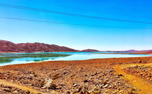 Scenic view of mountains against blue sky