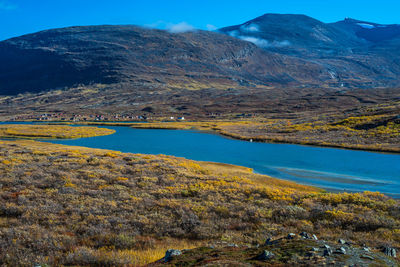 Scenic view of mountains against blue sky