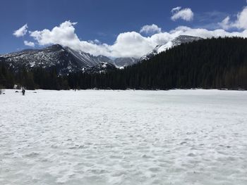 Snow covered landscape against mountain range