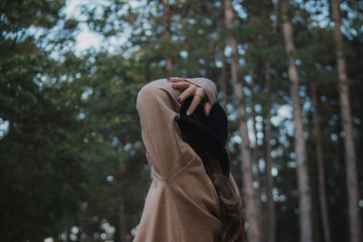 Midsection of woman against tree