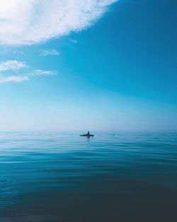 Scenic view of sea against blue sky