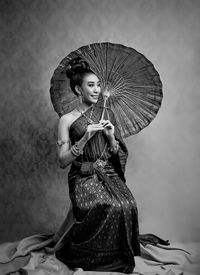 Portrait of young woman holding umbrella