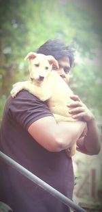 Close-up of woman with puppy