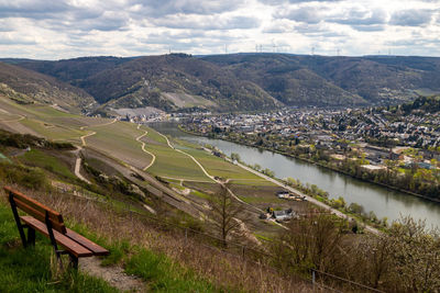 Panoramic view on the valley of the river moselle and the city bernkastel-kues with a brown bench