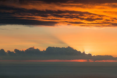Scenic view of sea against orange sky