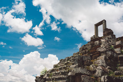 Low angle view of old building against cloudy sky