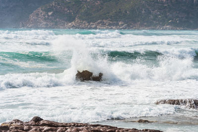 Waves splashing on rocks at shore