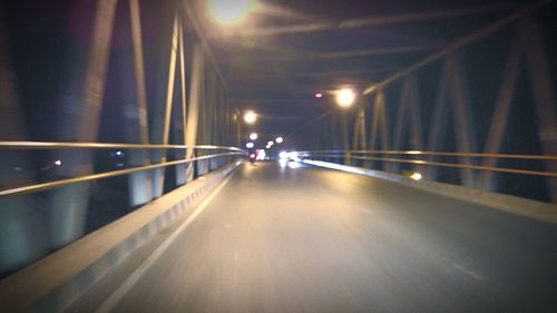 Illuminated bridge at night