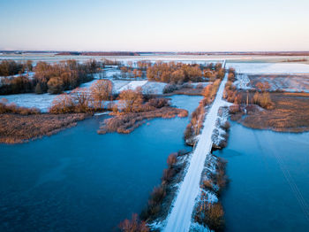 High angle view of river amidst land against clear sky