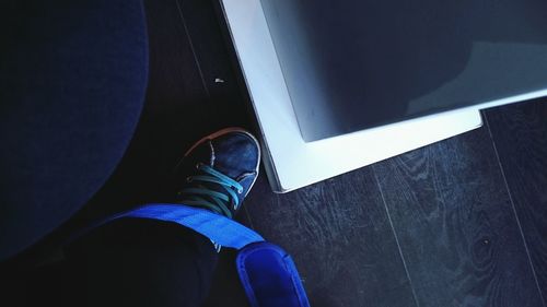 Low section of woman standing on tiled floor