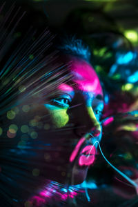 Digital composite image of woman and plasma ball with fiber optics