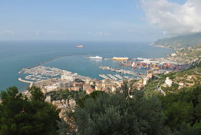 High angle view of buildings by sea against sky