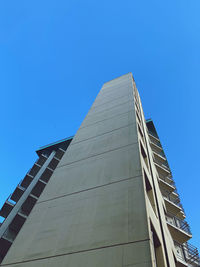 Low angle view of modern building against clear blue sky