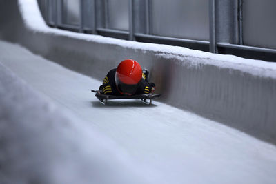 Man bobsledding on sports track