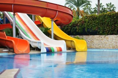 Low section of woman sitting in swimming pool