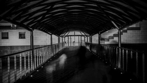 Man walking in corridor of building