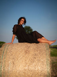 Smiling woman on bale