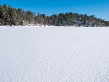 Scenic view of snow covered land against clear sky