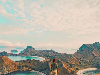 Man standing on mountain against sky