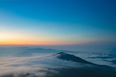 Scenic view of snowcapped mountains against sky during sunset