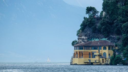 Building by sea against sky